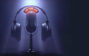 Headset on the microphone with the "On The Air" light on.